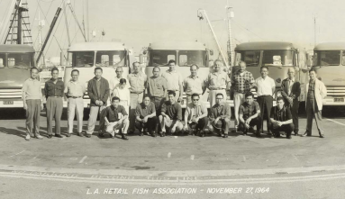 group of men in front of trucks